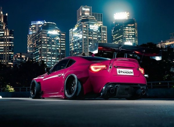 Rose red Toyota 86 modified with AIRRIDE low slung posture for 'late night body show'